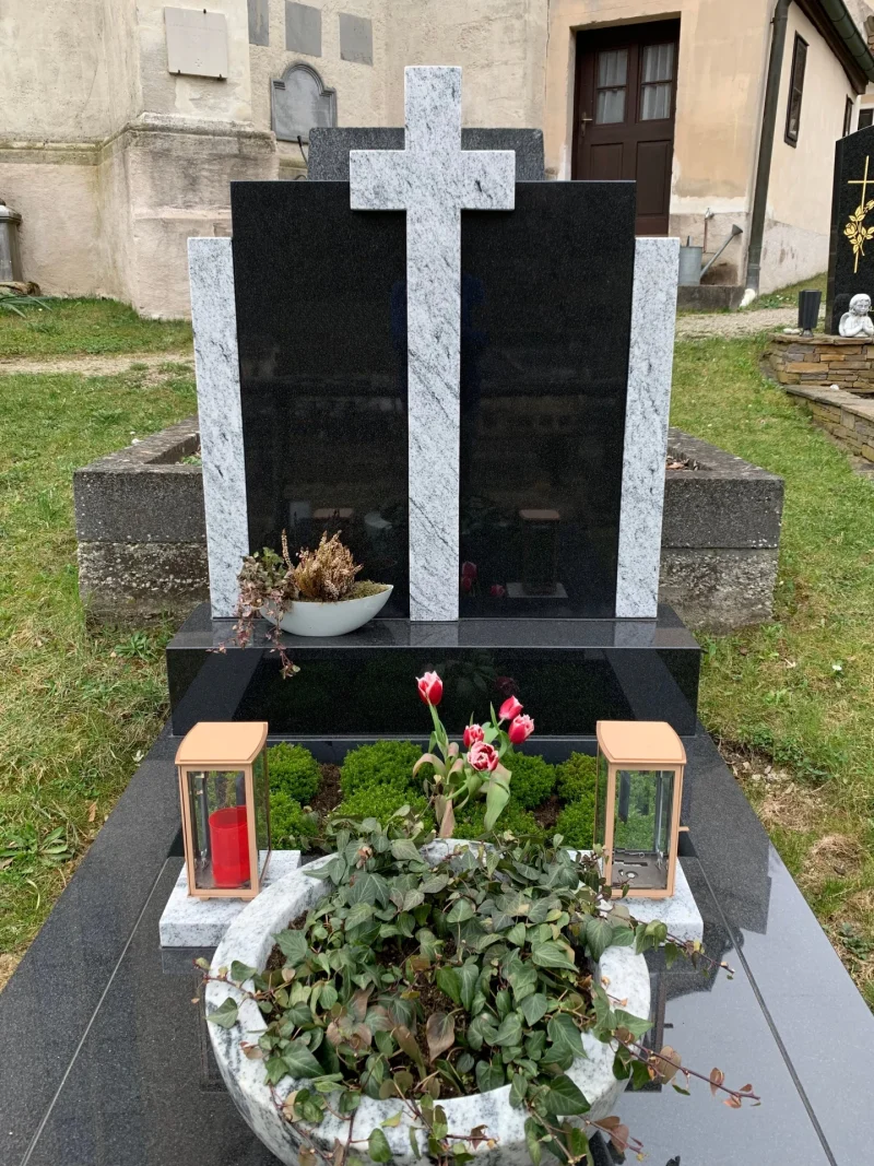 Moderner Grabstein aus schwarzem und weißem Granit mit einem Kreuz aus weißem Granit individuell gefertigt vom Steinmetz in Niederösterreich.