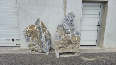 Wachauer Marmor 37 Wachauer Marmor Findling, aufgestellt als Gestaltungselement vor einer Mauer.